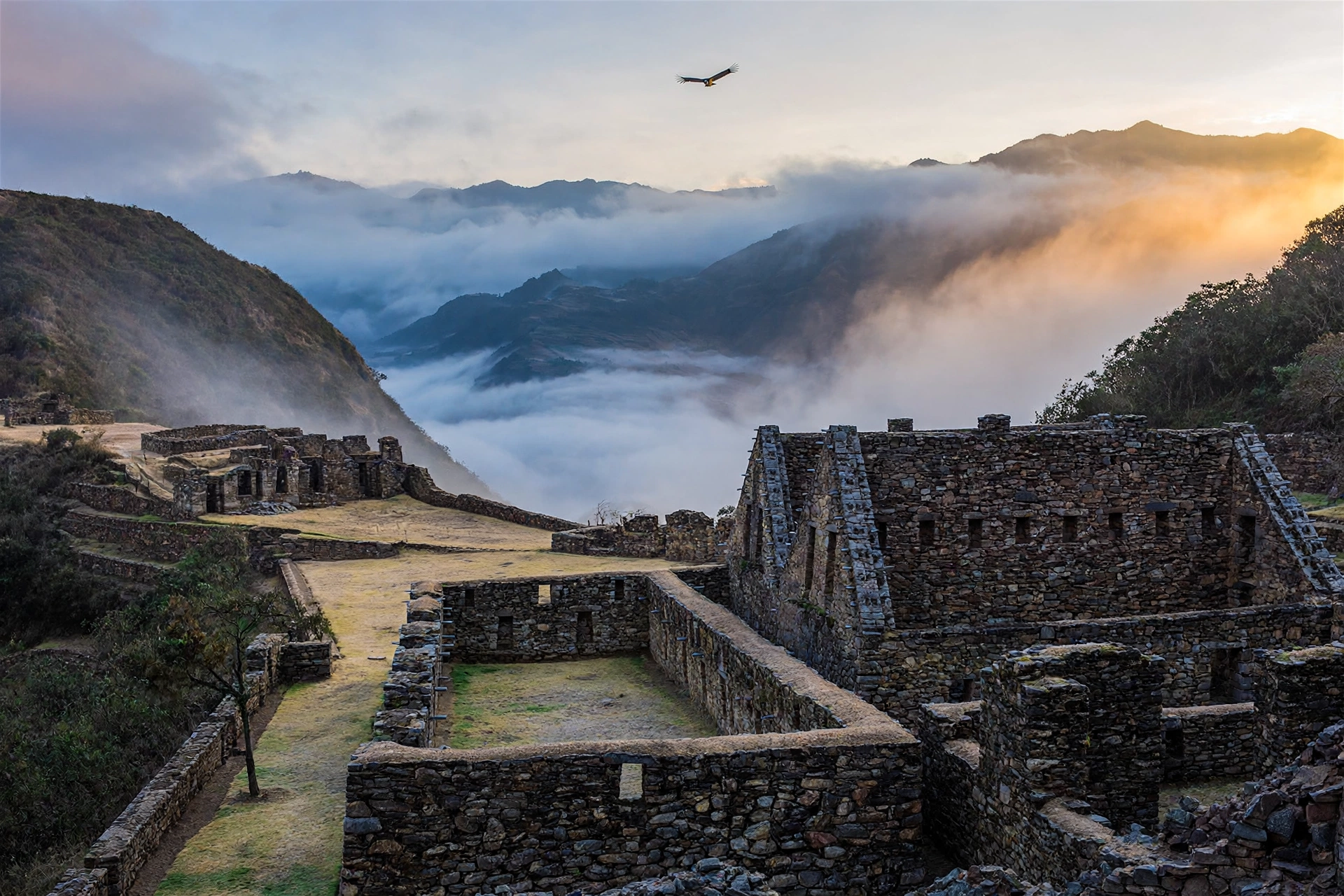 Sunrise over the main plaza of Choquequirao ruins in Peru with mist in the Apurimac canyon