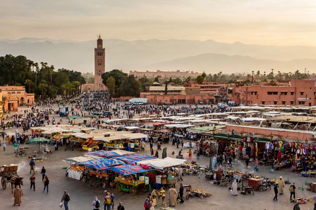 Jemaa el-Fnaa square and old medina of Marrakech Morocco in warm late afternoon light with Atlas Mountains haze